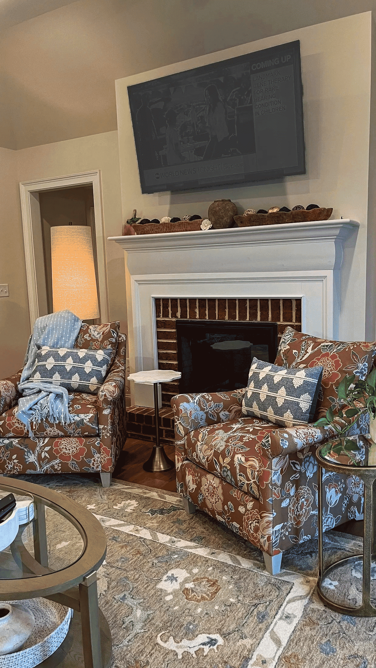 Fireside floral accent chairs in the living room at Georgia Cottage
