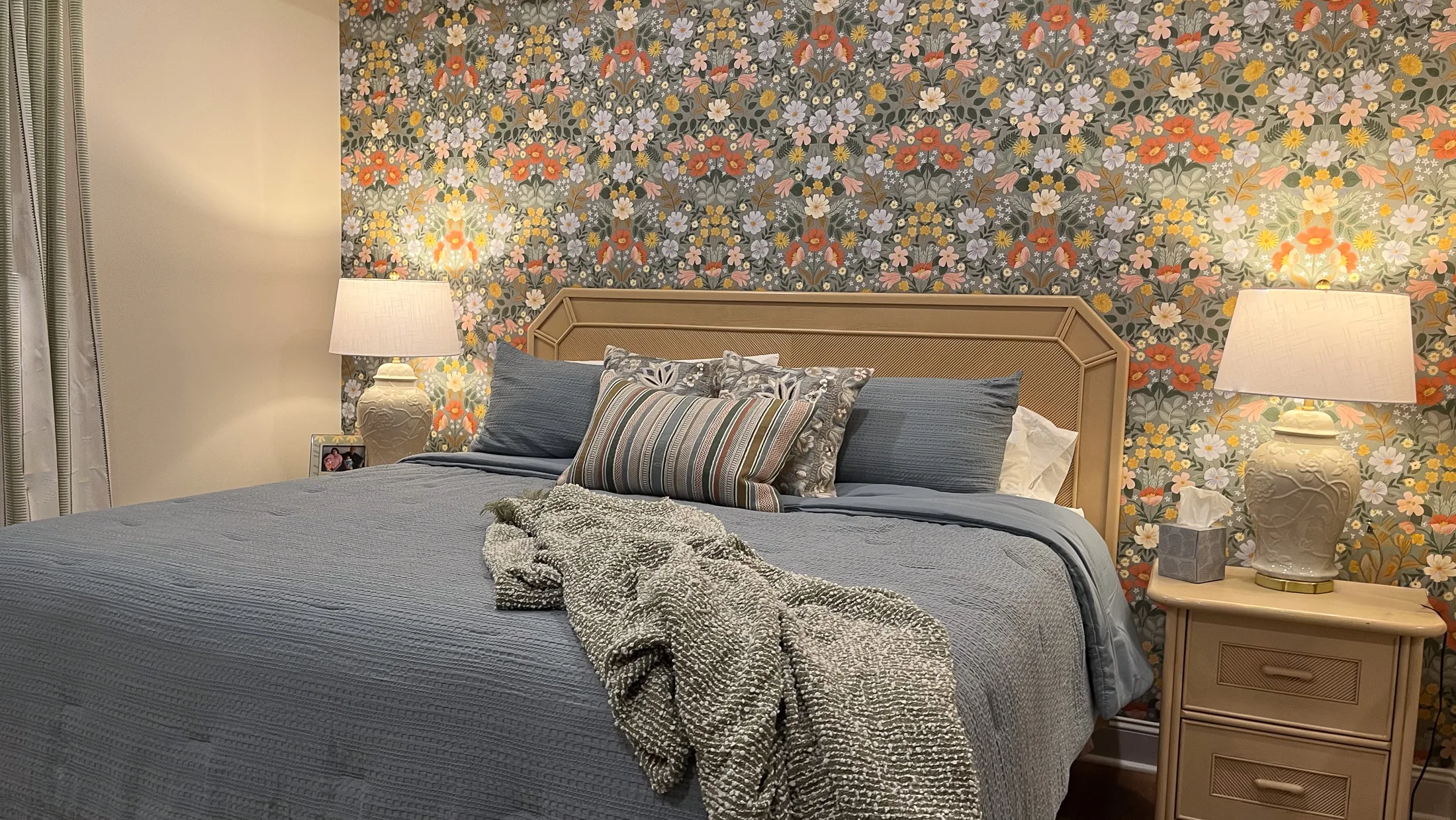 Primary bedroom with floral wallpaper at Georgia Cottage